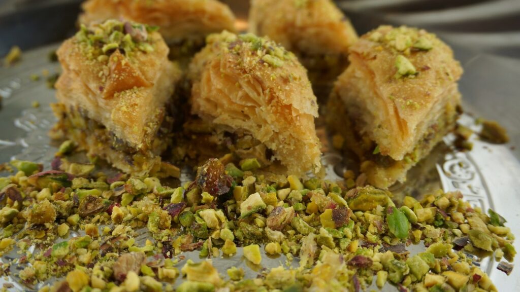 Greek baklava dessert on a dish topped with pistachios