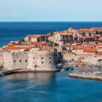 old stone fortress with bright orange tile roofs in dubrovnik croatia