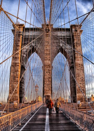 Brooklyn Bridge with a few visitors, showcasing its beauty that is one of the best Places to Visit in the USA